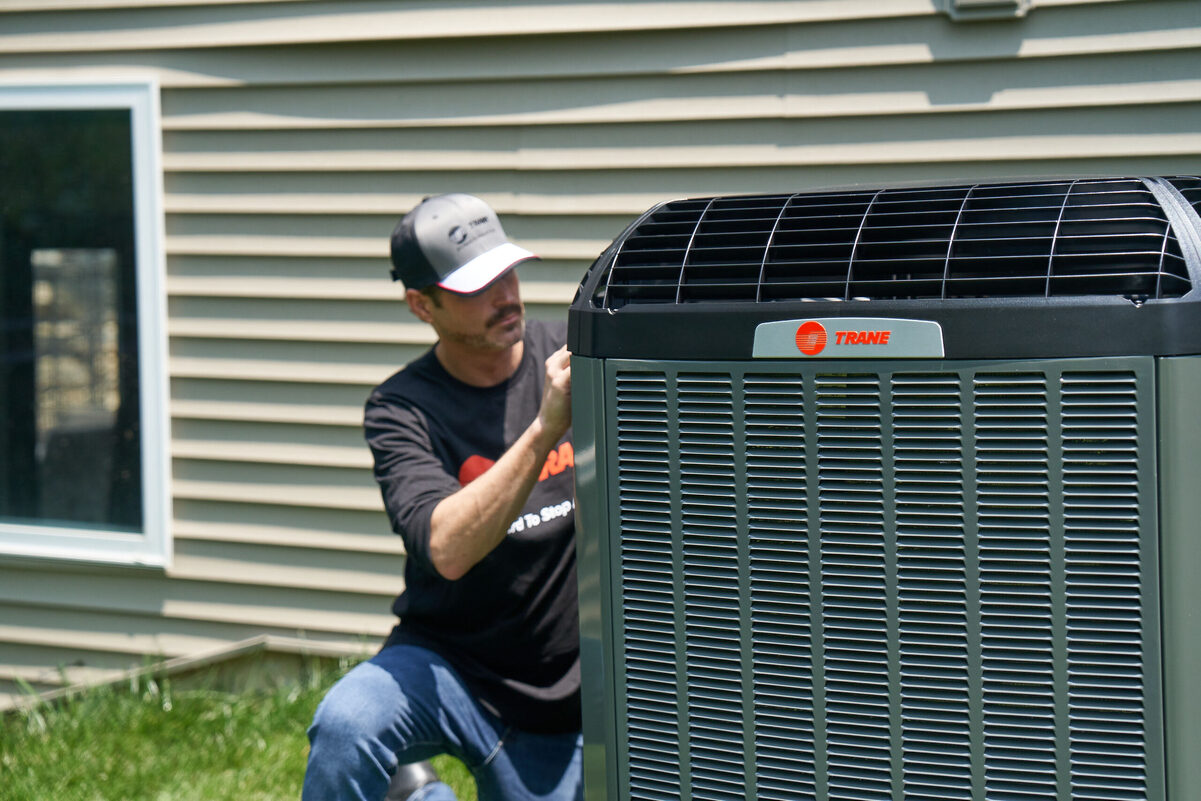 HVAC technician servicing outdoor unit